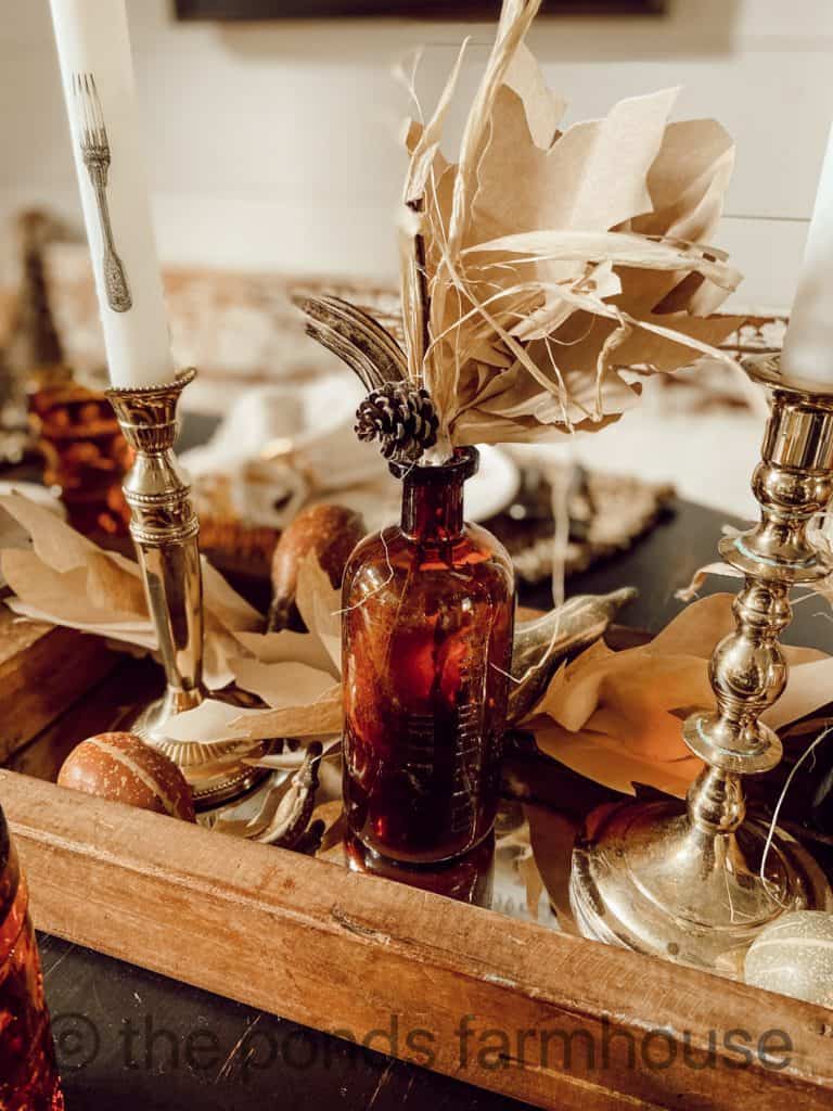 Amber Bottle and vintage candlesticks for Thanksgiving Tablescape ideas.