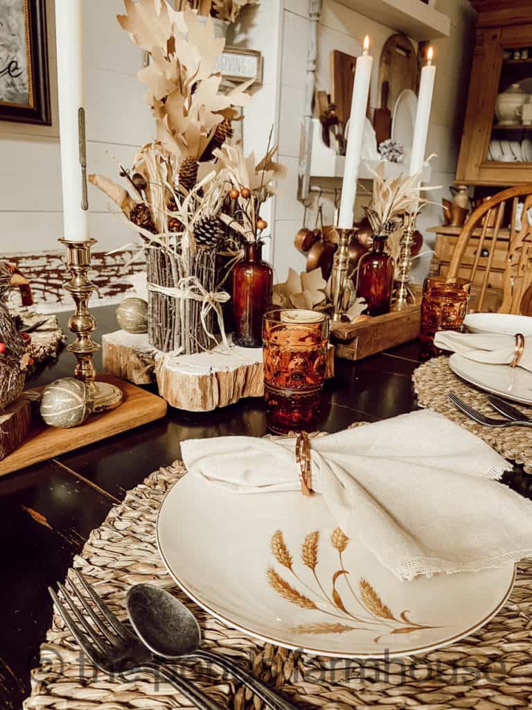 Leaf Placemats, Wheat Plates, copper napkin rings and DIY centerpiece complete Thanksgiving Tablescape ideas.