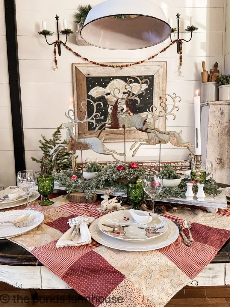 Long view of Christmas Table Setting with Reindeer Centerpiece on DIY Riser & DIY Patchwork Table Cloth