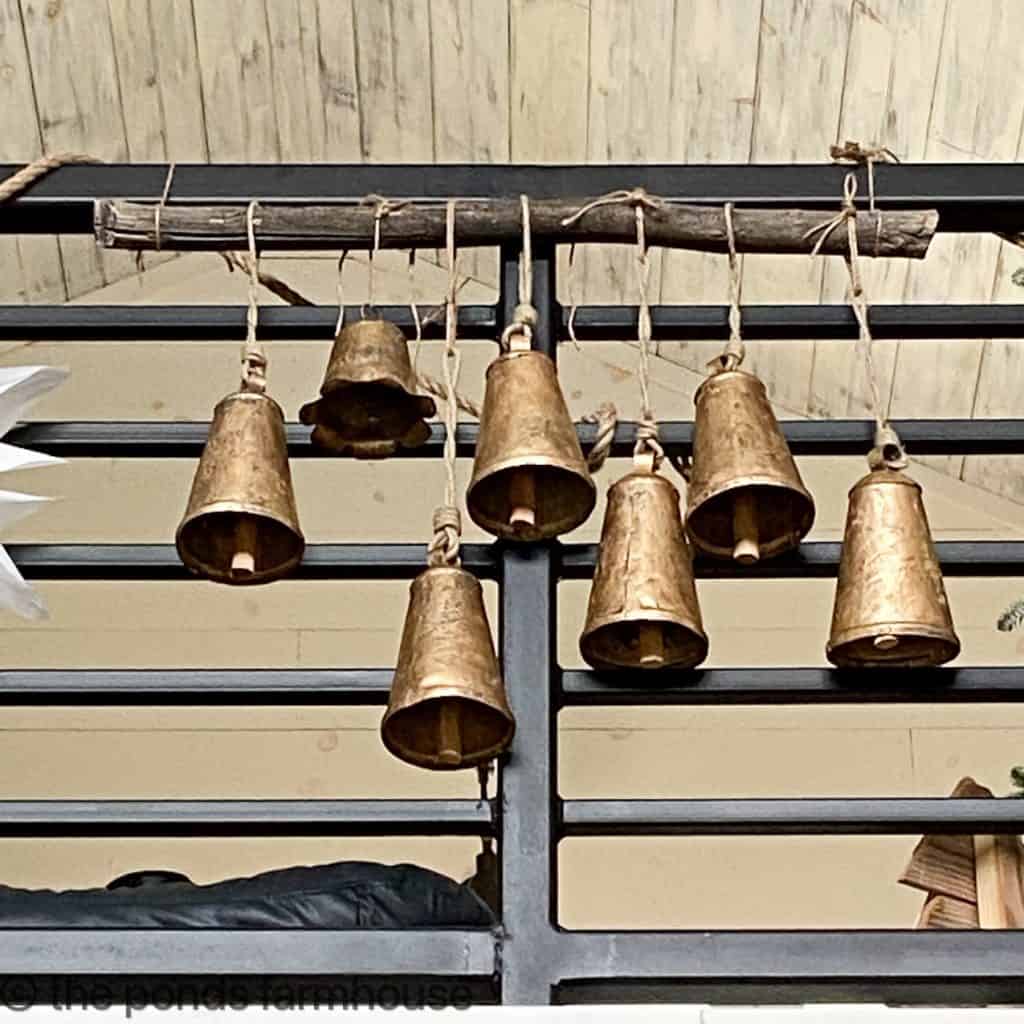 Vintage Inspired Gold Bells hang from a tree branch on the Industrial Style Banister