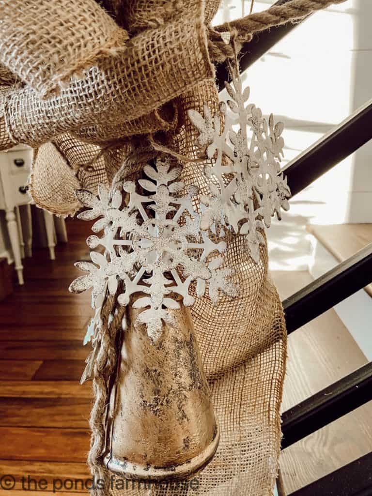 Close up view of burlap bow at the end of the banister Christmas Garland