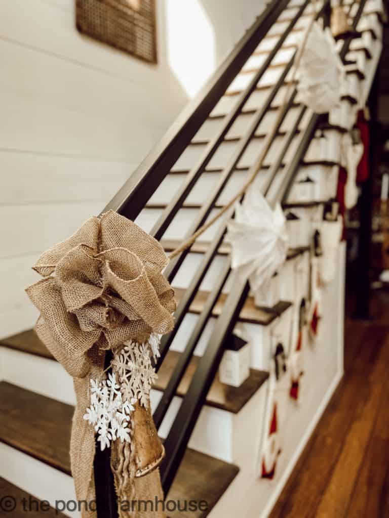 Burlap Bow with metal snowflakes finishes the farmhouse Christmas Garland.