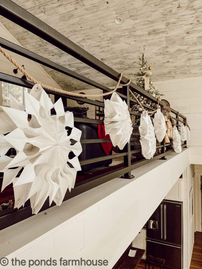 Easy Christmas Craft - DIY Paper Snowflakes for a banister garland.  