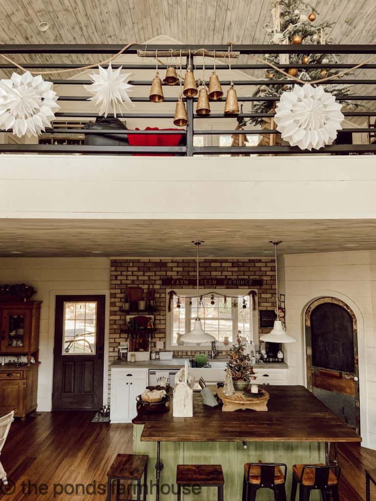Modern Farmhouse Christmas Garland is focal point of open floor plan.  DIY Paper Bag Snowflakes & Brass Bells