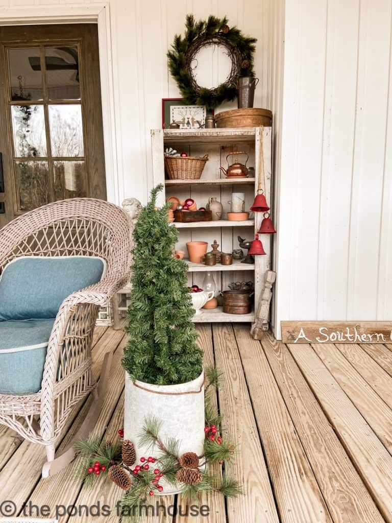 Christmas tree in chicken feeder surrounded by garland.  