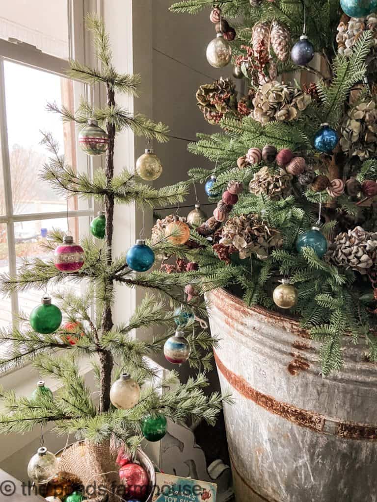 Close up of mini Christmas tree located beside the larger tree.  Farmhouse style Christmas Decorating