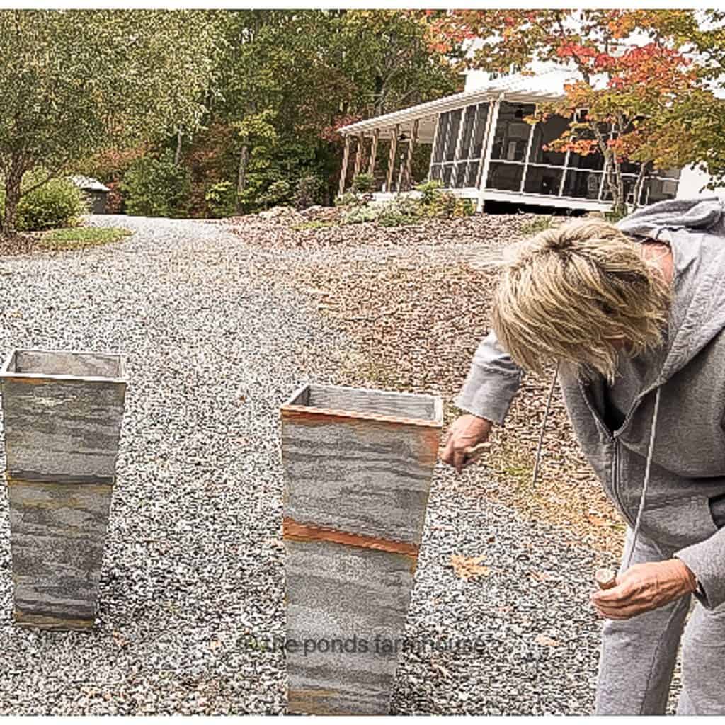 Using a faux technique for DiY Planters to look like galvanized planters.