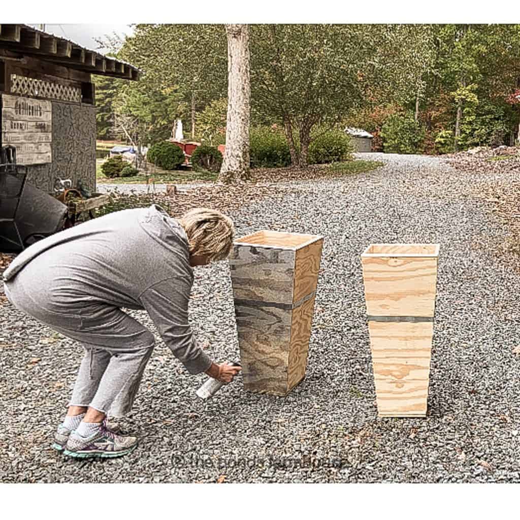 Paint wooden planters to look like galvanized planters.  