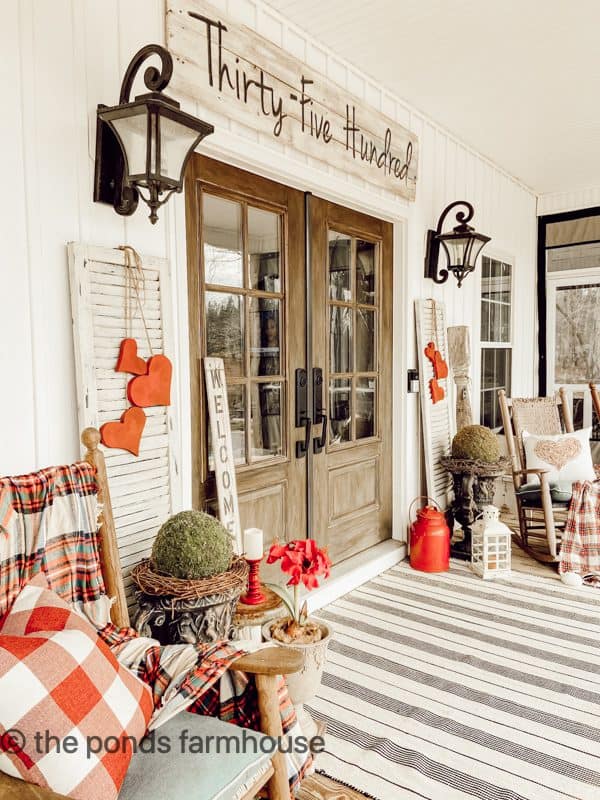 Valentines Outdoor Porch Rug with black stripes and red wooden hearts beside front french doors.