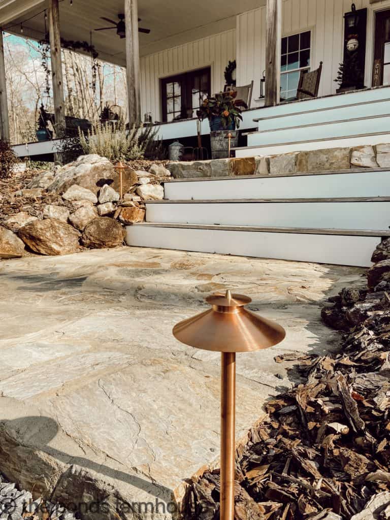 Raw Copper Landscape Lighting enhances the rock walkway.