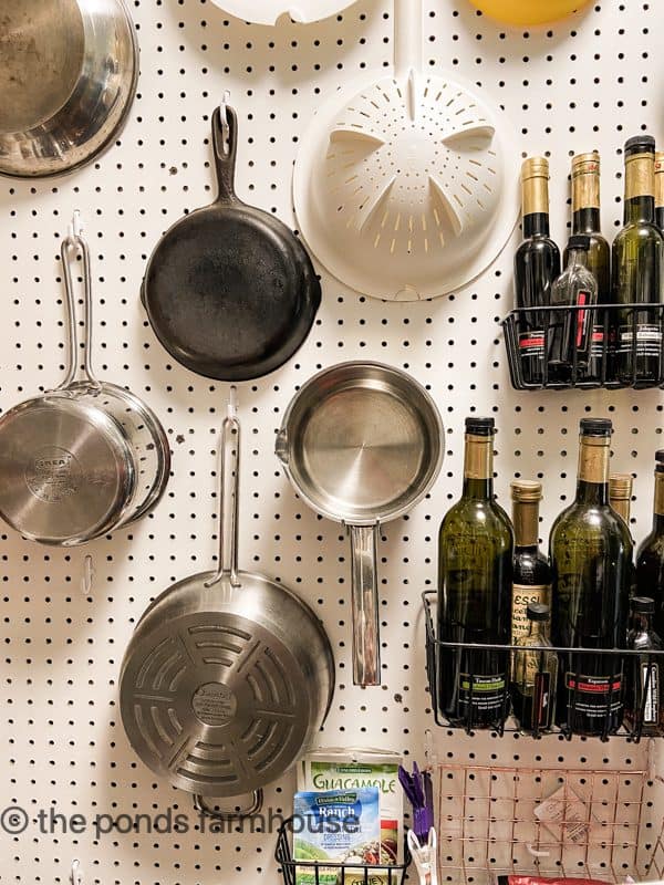 See pots and pans hanging on peg board in pantry best organizing tip.