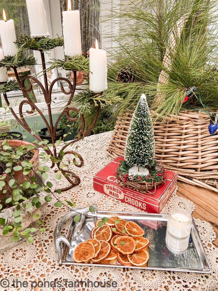 DIY Greenhouse Decorated for Christmas with dried oranges and DIY candle ring