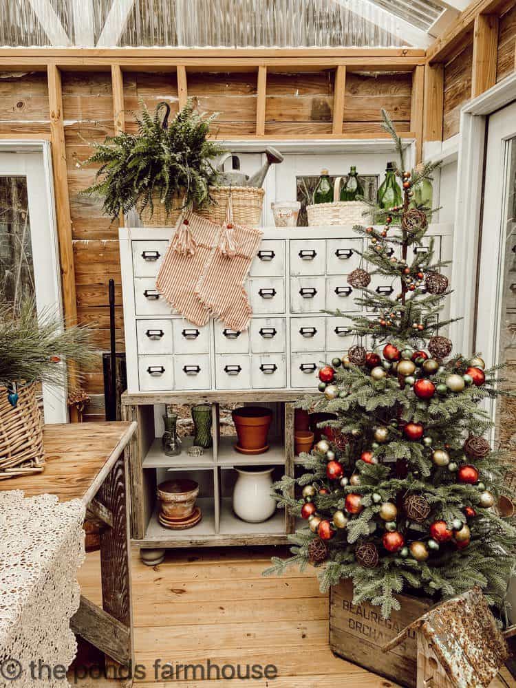DIY Greenhouse Decorated for Christmas with decorated tree and DIY apothecary cabinet 