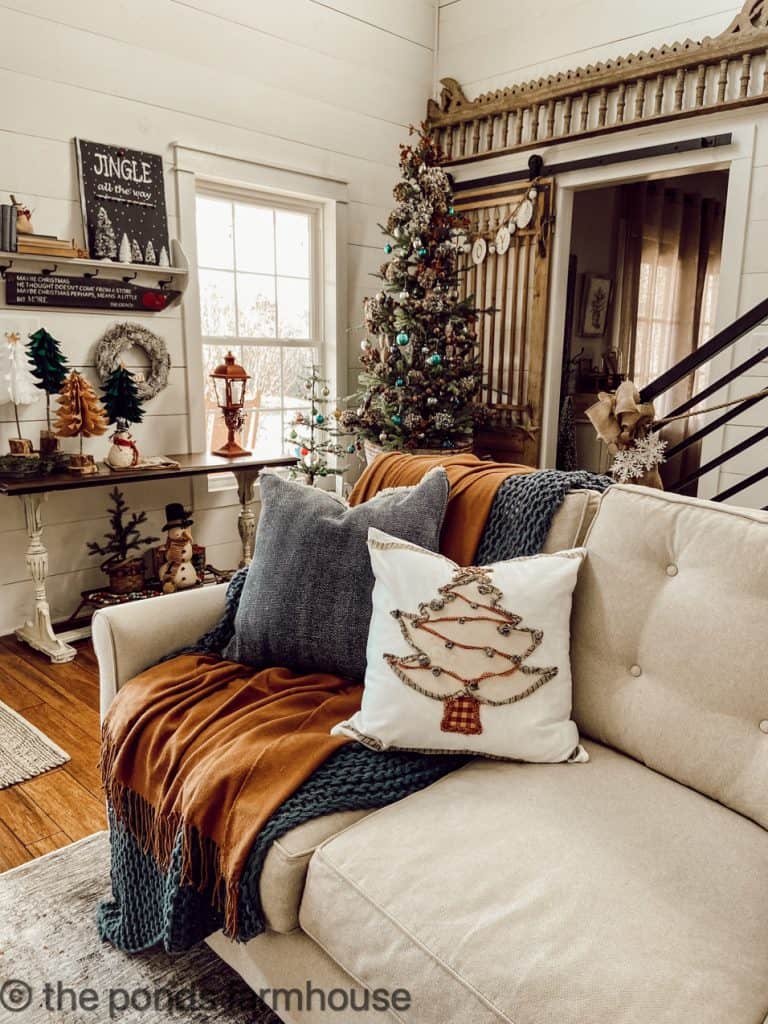 DIY Christmas tree pillow with ripped cloth, bells, and coffee stain.