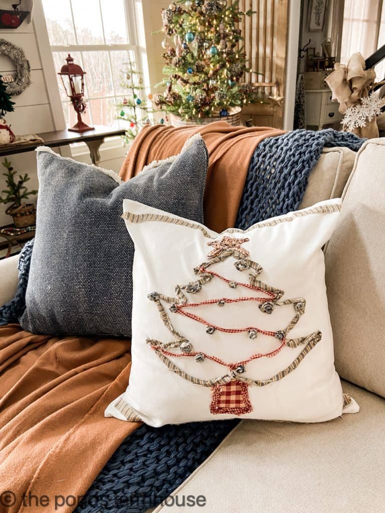 DIY Christmas tree pillow using ripped cloth and bells.