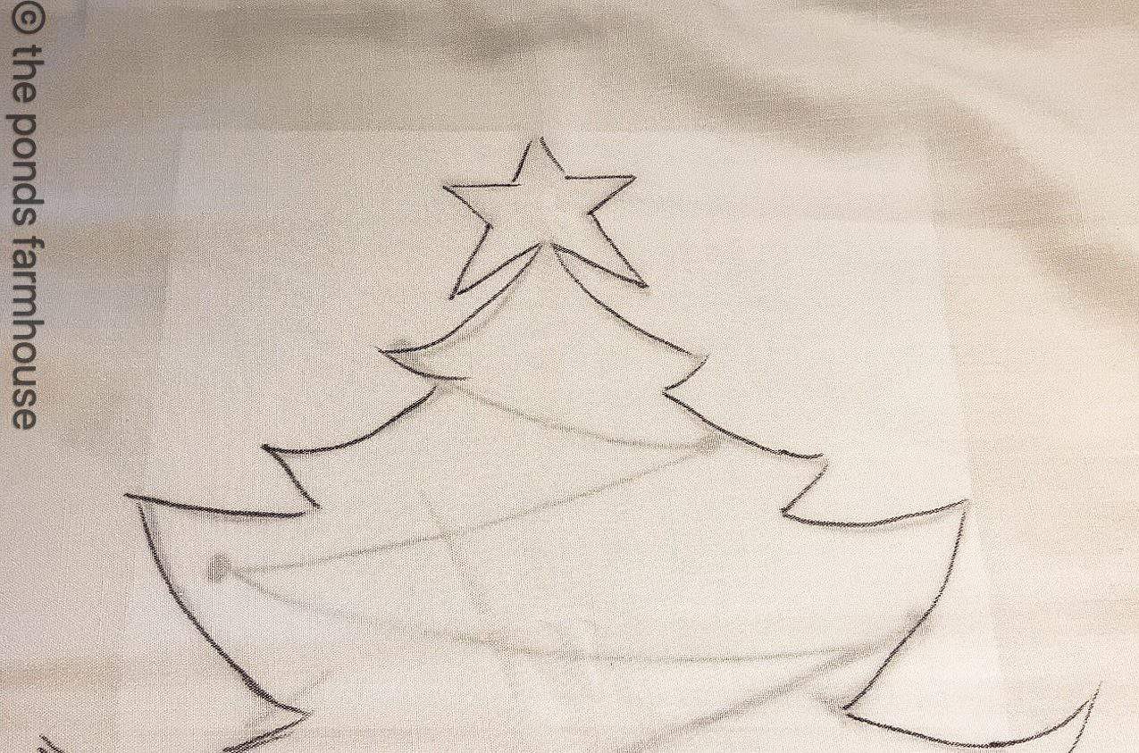 Christmas tree pillow outline on cloth.