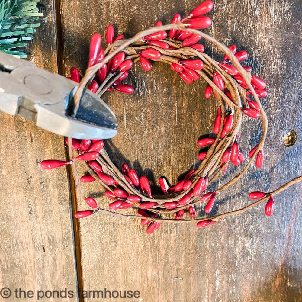 Cut the Dollar Tree berry garland with wire snips