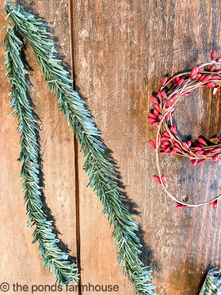 Dollar Tree cedar ties and berry garland to make DIY Holiday Candle Rings