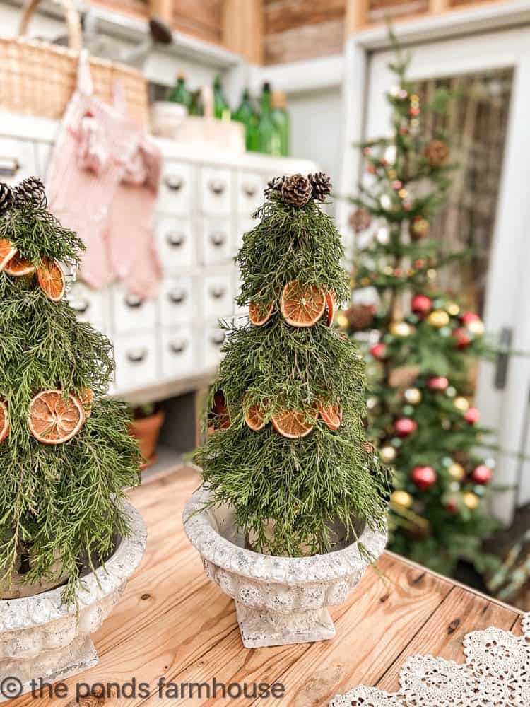 DIY real cedar and dried orange topiaries for Christmas Table Decorations.