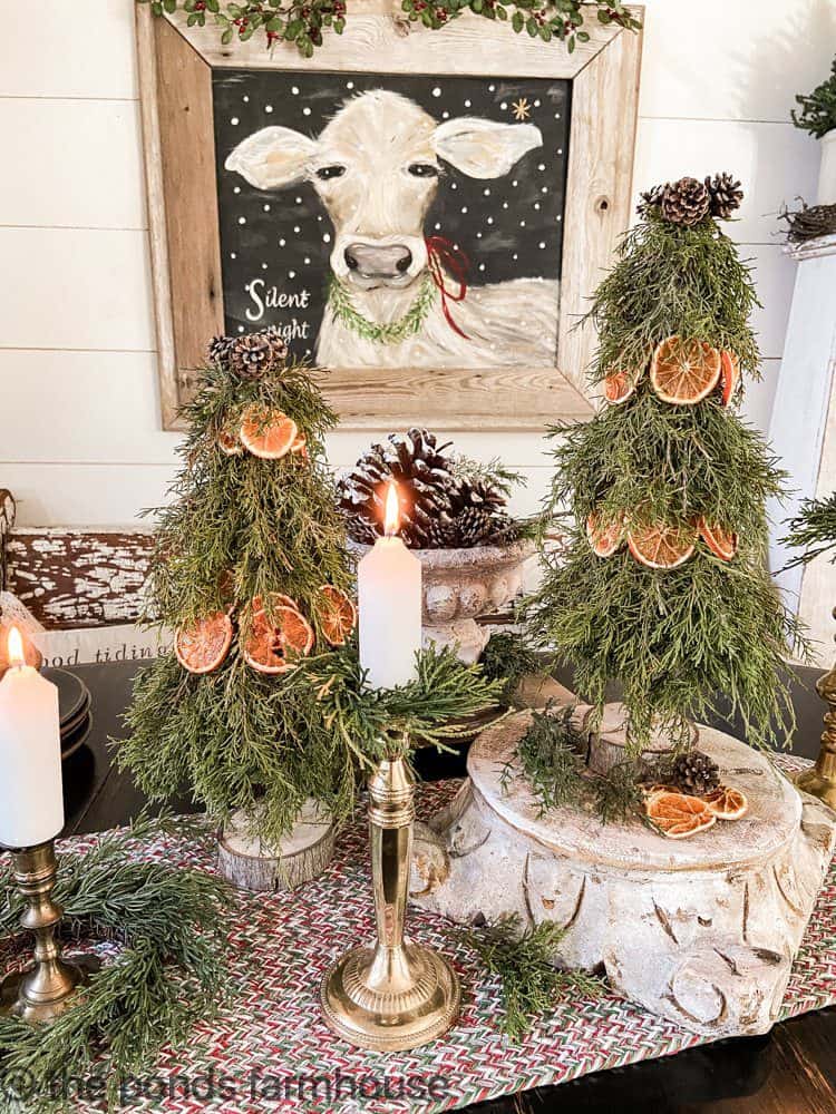 DIY Real Cedar and Dried Orange Topiaries make Christmas Centerpiece with Silent Night Cow Painting.