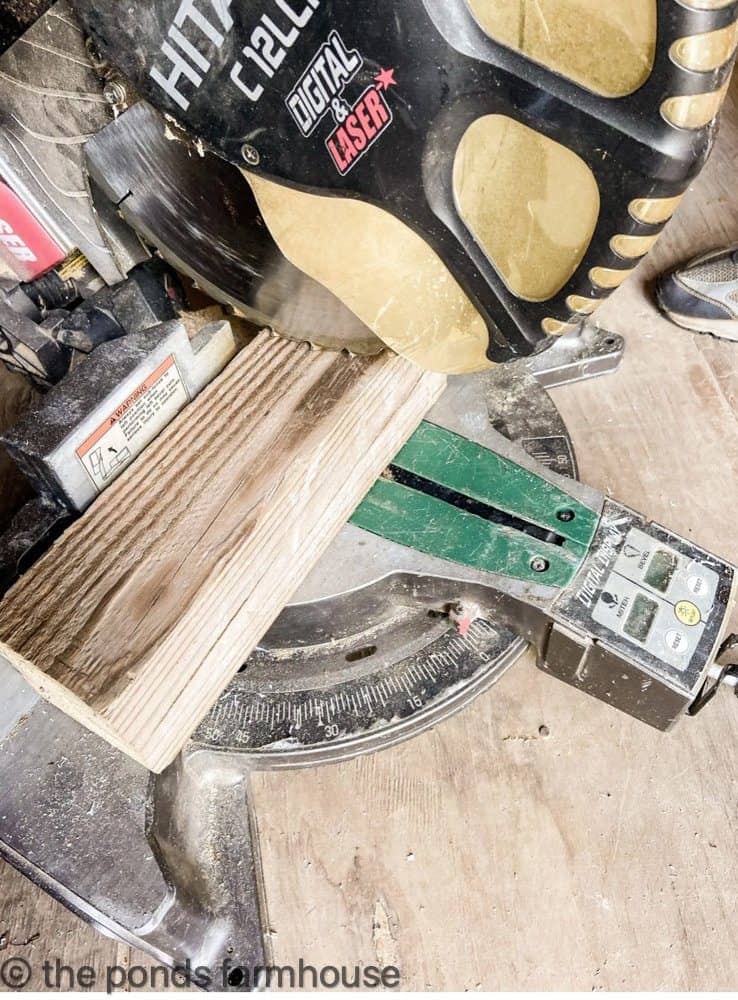 Use a miter saw to cut the different wood lengths for a shiplap Christmas Tree.