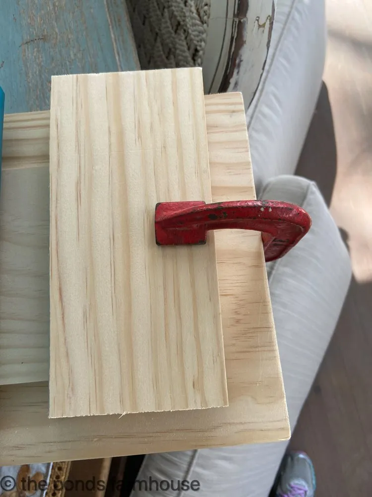 Use clamps to hold the glued pieces of the table riser together