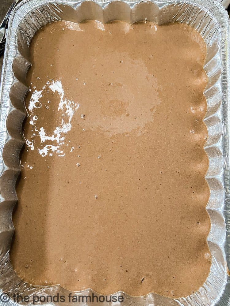 Upside down German chocolate cake mix in disposable tin pan.