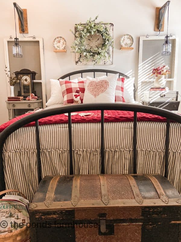 Antique Iron Bed with Black and white ticking stripe bedding mixed with red and white for Valentine's Day