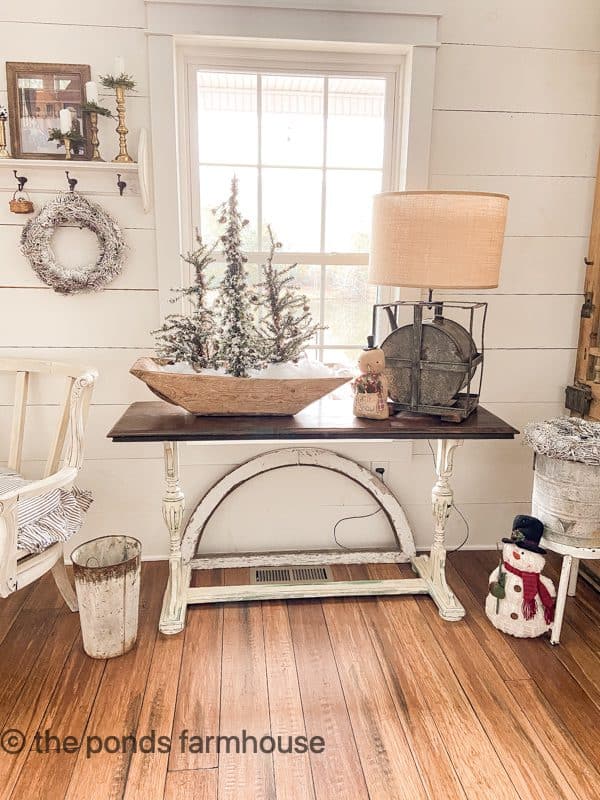 Snowy faux trees in a Vintage dough bowl and repurposed gas can lamp for January Decor Ideas