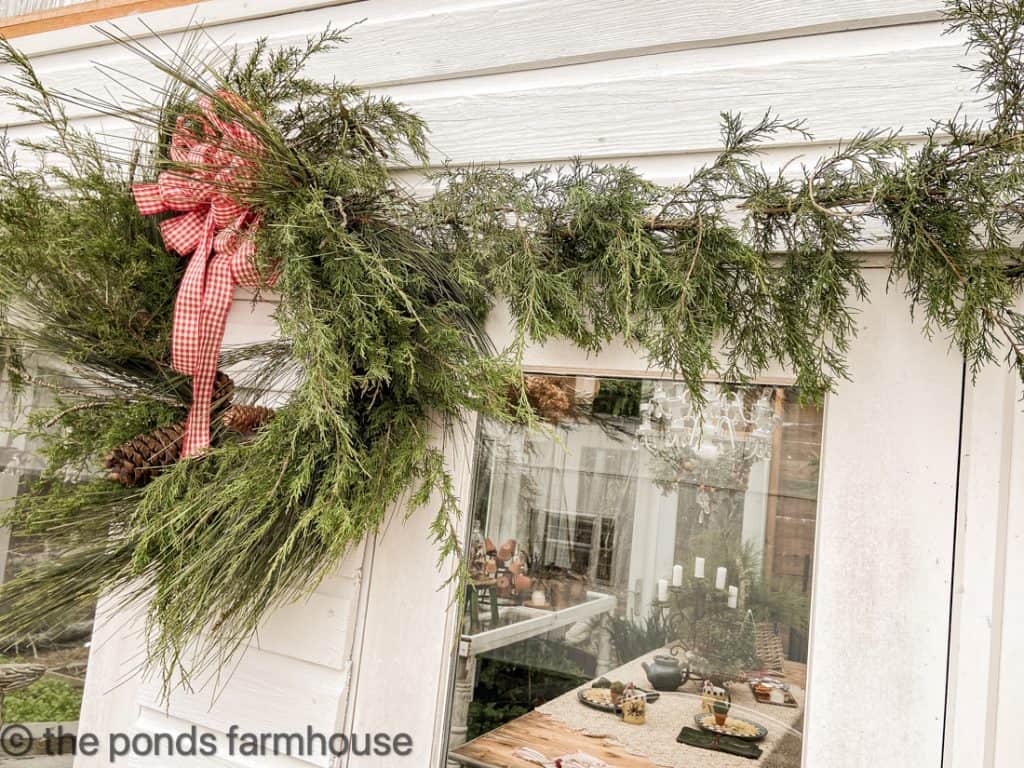 Fresh Cedar Garland and a pine and cedar wreath on greenhouse.