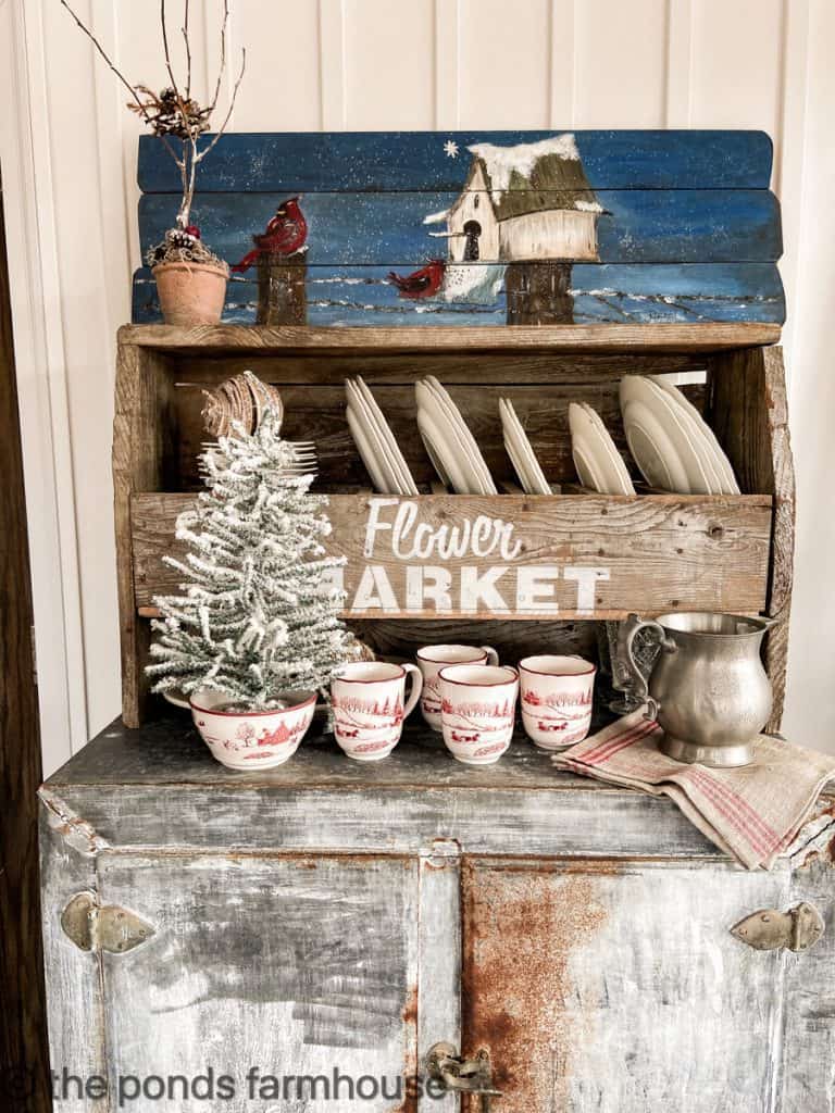 Vintage Ice Box with Christmas mugs. Vintage white plates.