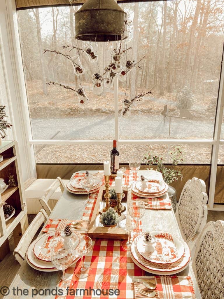 Oil can light fixture with vintage Christmas tablescape.