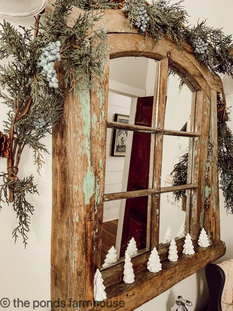 Antique window repurposed as a bathroom mirror for a vintage decorating idea.