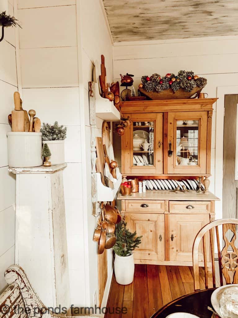 Antique Honey Pine Hutch with Vintage Dough Bowl filled with dried hydrangeas and shiny brite ornaments.