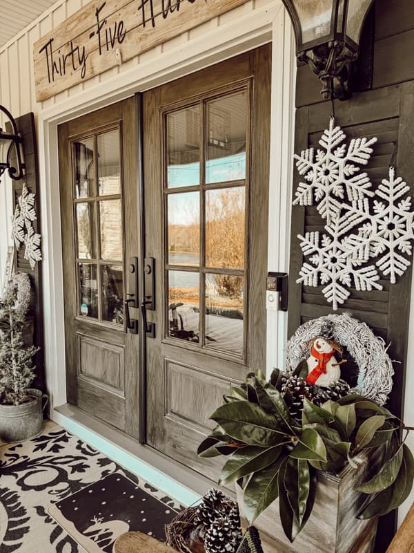Front Porch Winter Decorating.  with fresh magnolia evergreens and dollar tree snowflakes for a winter outdoor planter idea. 