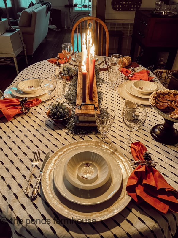 Cozy Table setting by candlelight from the DIY centerpiece.  