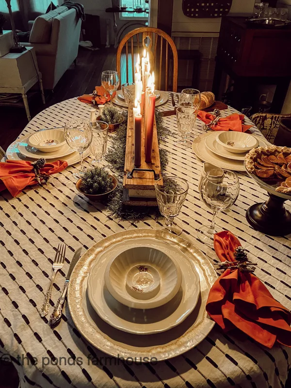 Cozy Table setting by candlelight from the DIY centerpiece.  