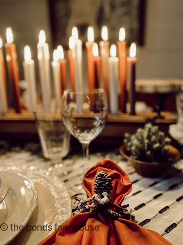 Thrifted Tableware fill a cozy winter tablescape in candlelight
