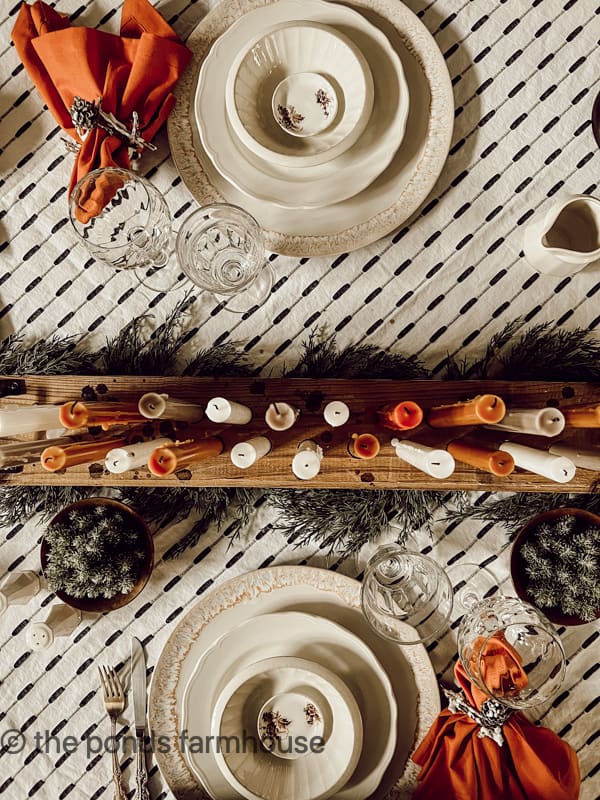 Not flower centerpiece for a rustic fall table setting with a multiple candle centerpiece.