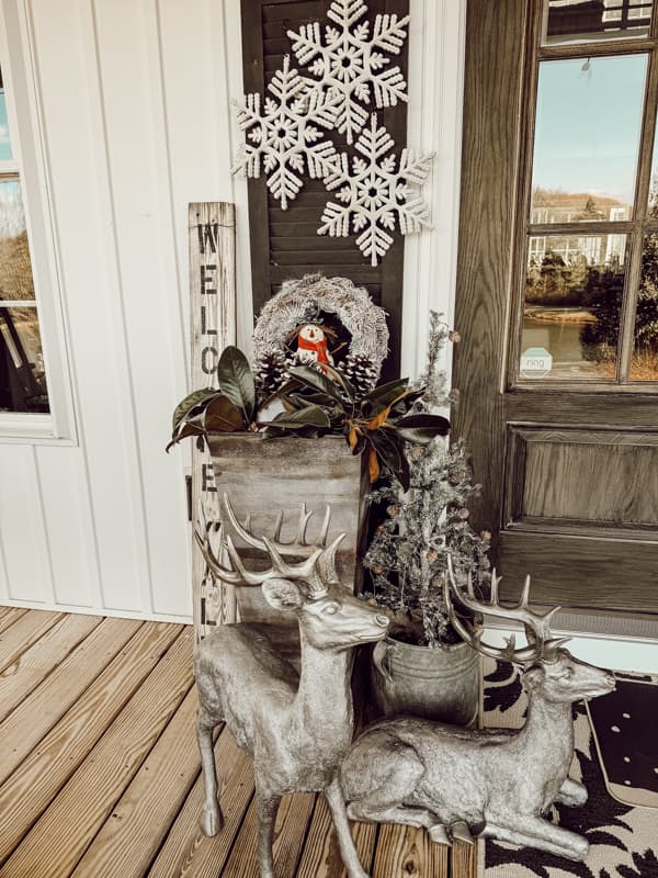Create a winter wonderland on your winter front porch with winter outdoor planter ideas.  Deer and Snowmen and frosted trees.  