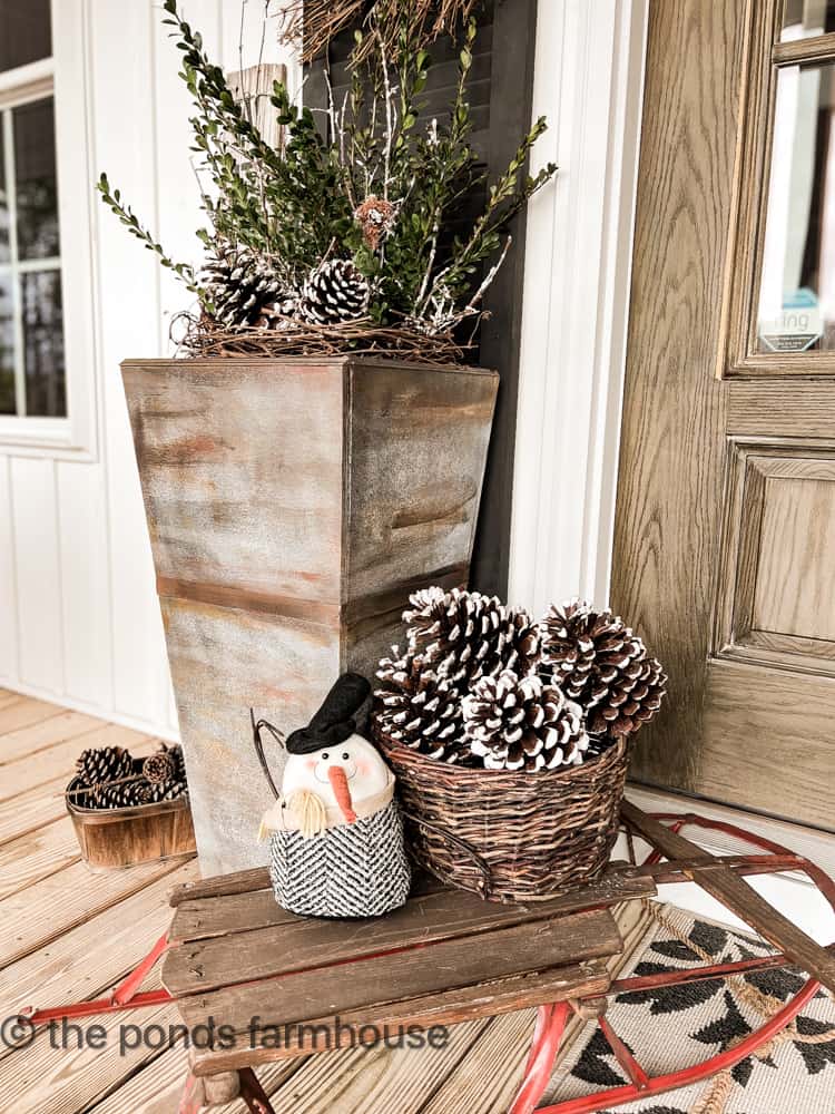 Pinecones and snowman on vintage sleigh and front porch planters for Winter.