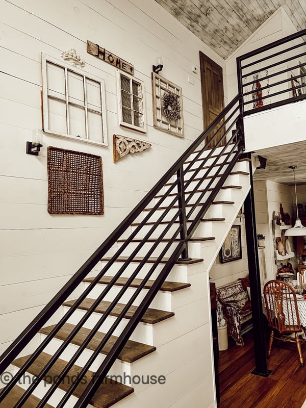 Industrial Loft staircase and salvaged window gallery wall. 