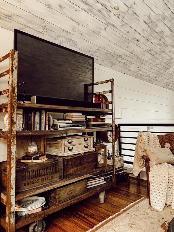 Industrial Cart reinvented as TV Stand is warmed with old vintage crates.