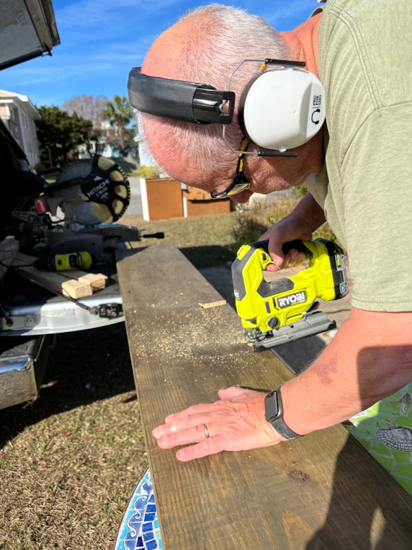 Safety precautions while cutting the shelving for handmade rustic kitchen cabinets in tiny house beach cottage.