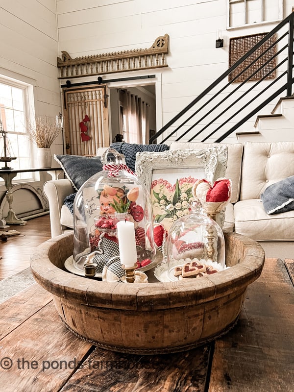 Antique wooden bowl filled with Cloches for Valentines Day Decorating. 