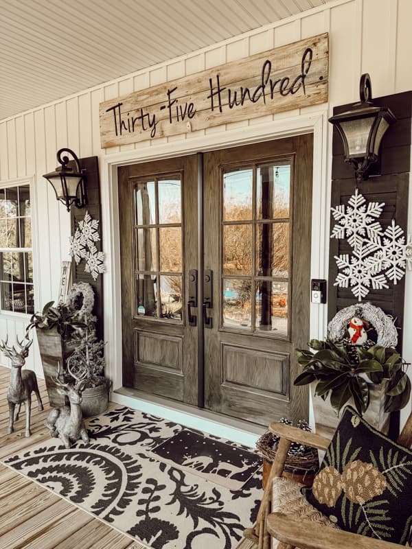 Create a winter wonderland on your winter front porch with winter outdoor planter ideas with snowflakes and reindeer.