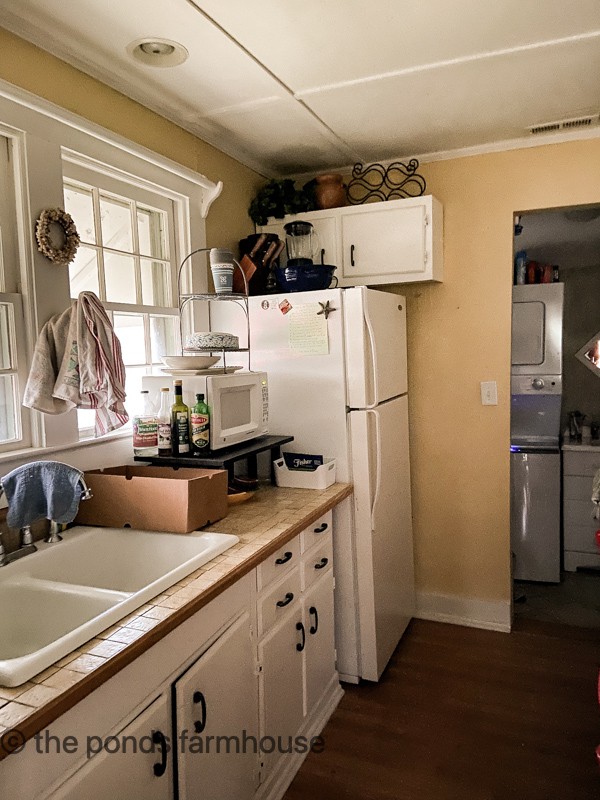 Beach cottage renovations before kitchen cabinet.  with outdated and damaged materials.  Budget-Friendly Remodel