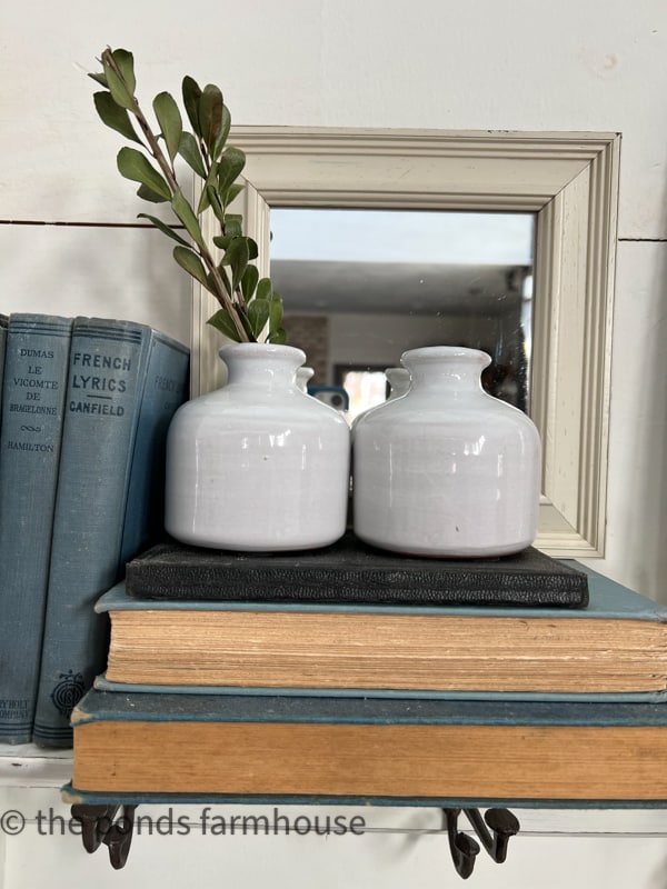 Books and porcelain vases on entryway shelf.  Country Chic and Cottage Style Shelf Decorating.