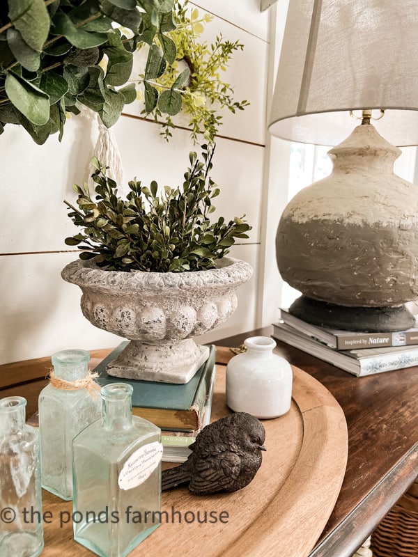 Entry table decorated for Spring with boxwood greenery and DIY Thrift Store lamp