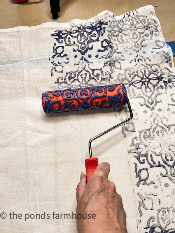 Roll the paint roller to make DIY hand painted flour sack napkins
